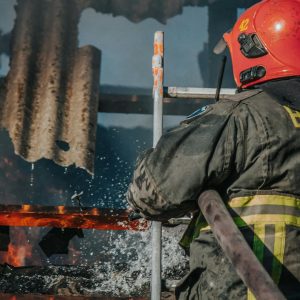 Dedicated firefighter extinguishing flames in a burning building.