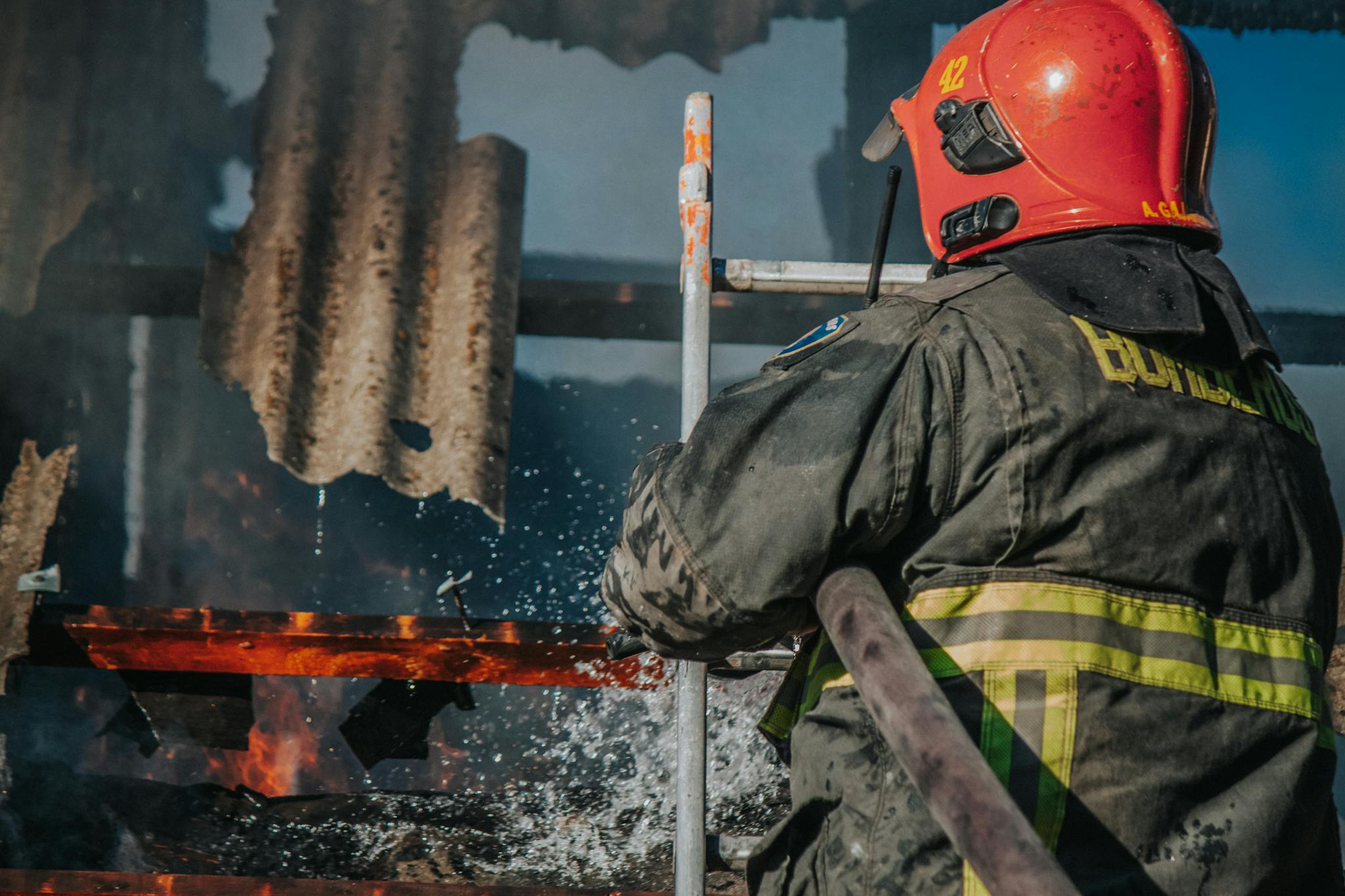 Dedicated firefighter extinguishing flames in a burning building.